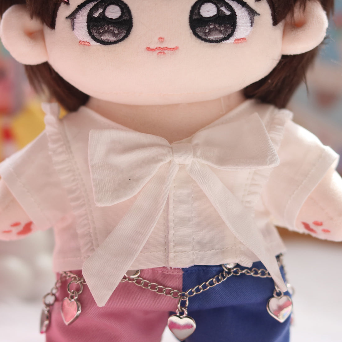Close up of bow and heart chain on outfit