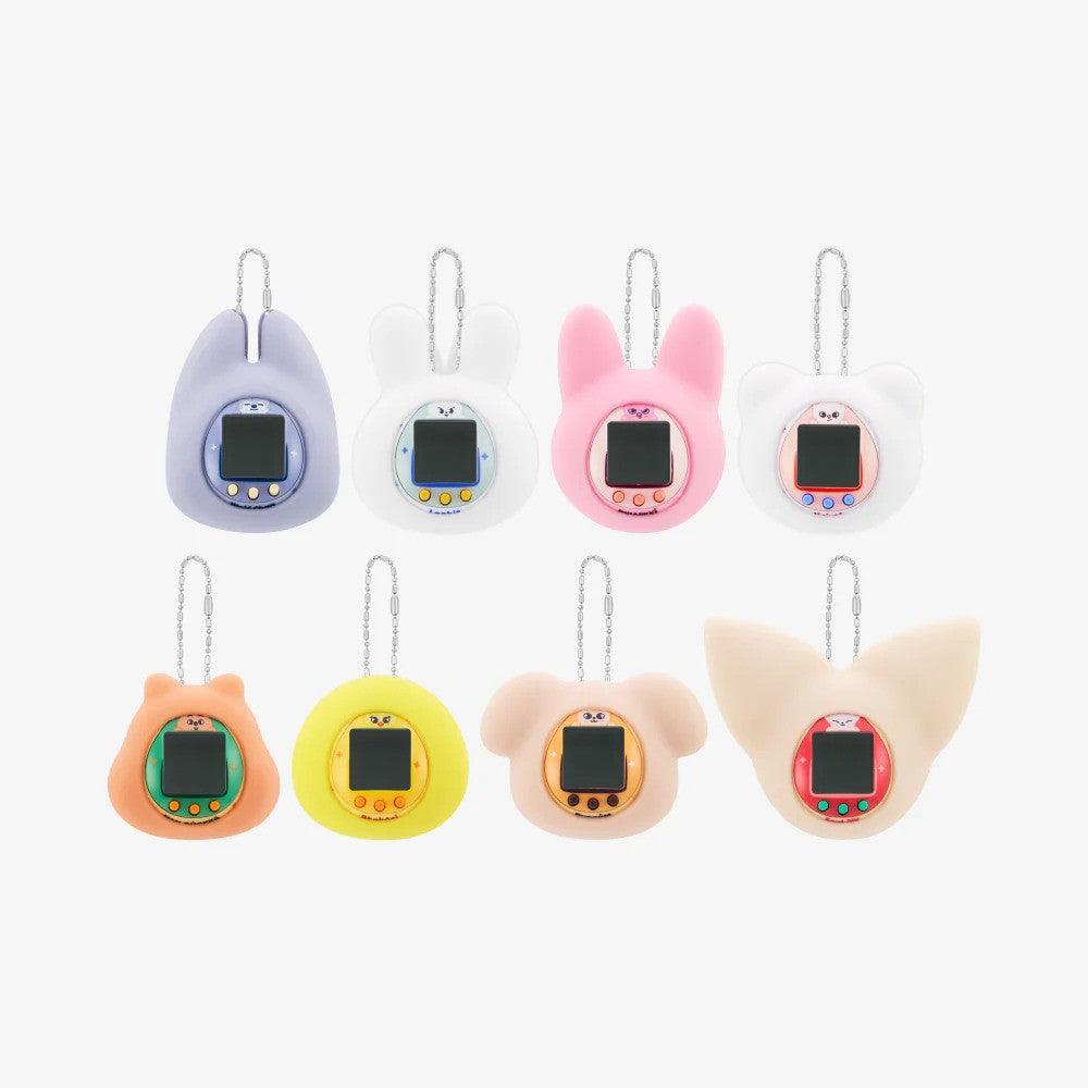 A collection of 8 colorful digital tamagotchi toys attached to a keychain ring, each representing a Stray Kids band member.
