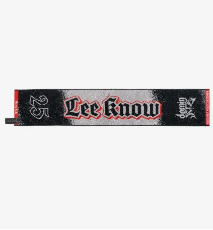 Photo of black, red and gray towel with Lee Know’s name