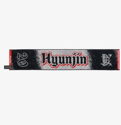 Photo of black, red and gray towel with Hyunjin’s name