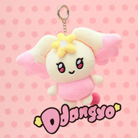 Plush keychain with a cute design on a pink polka dot background
