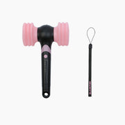 An official BLACKPINK light stick version 2 with a black handle and pink tips, along with a black lanyard with a small pink tag.